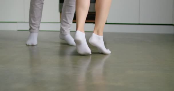 Close up feet young woman and man dancing at kitchen - 映像、動画