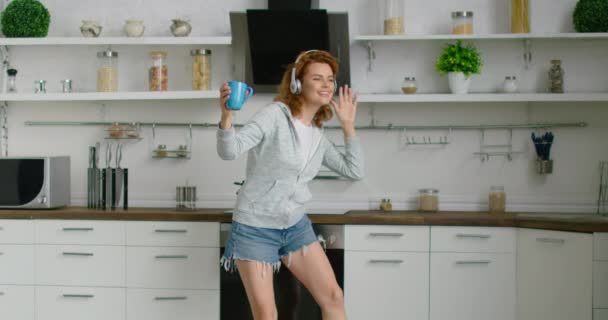 Young woman is dancing in her new kitchen - Felvétel, videó