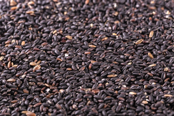 The raw black rice as background - Photo, Image