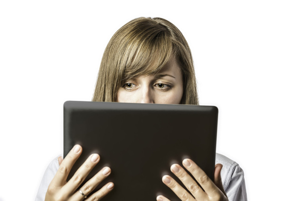 Pretty woman looks on tablet computer - Foto, imagen