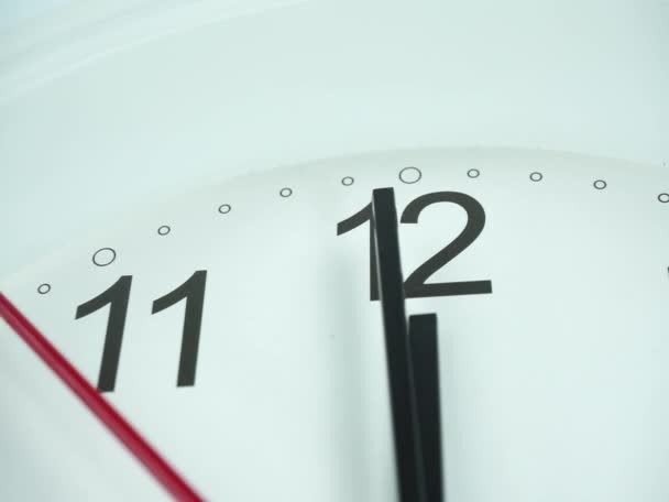Closeup White wall clock face beginning of time 11.59 am or pm, Clock minute walk slowly, Time concept. - Footage, Video