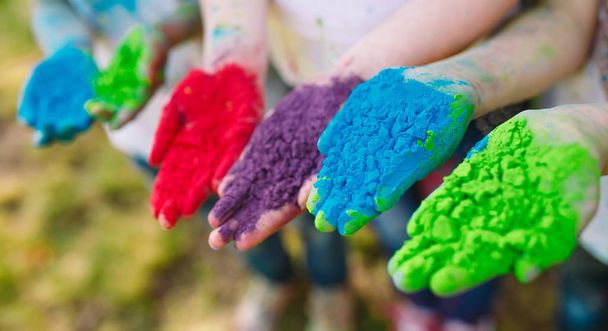 Hands Palms of young people covered in purple, yellow, red, blue Holi festival colors isolated - 写真・画像