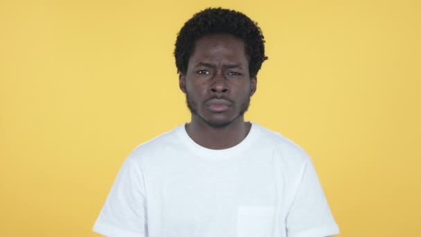 Disliking Young African Man Rejecting Offer Isolated on Yellow Background - Video
