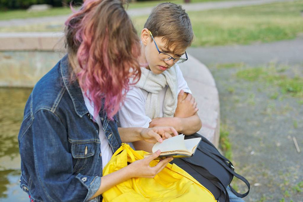 Outdoor portrait of two talking teenagers students - Fotografie, Obrázek