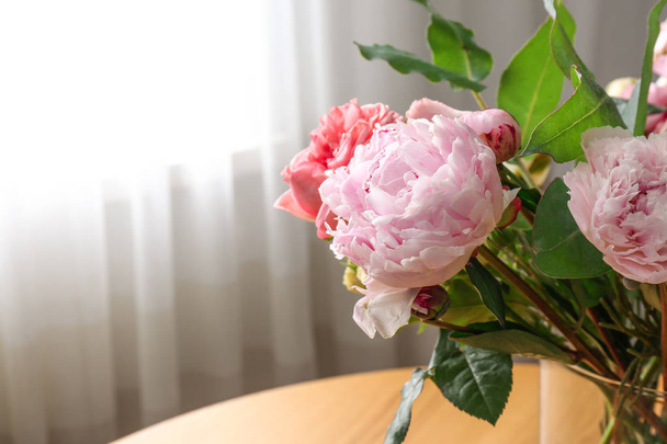 Beautiful flower bouquet in vase on table near window at home. Space for text - Foto, Imagen