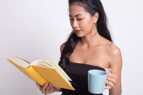 Young Asian woman with a book and cup of coffee. - Foto, imagen