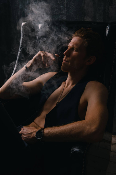 man smoking a cigarette. Cigarette smoke spread. - Foto, Imagen