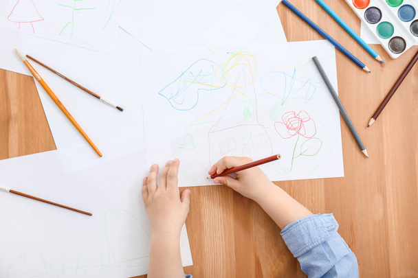 Cute little child drawing at table, top view - Foto, Imagen