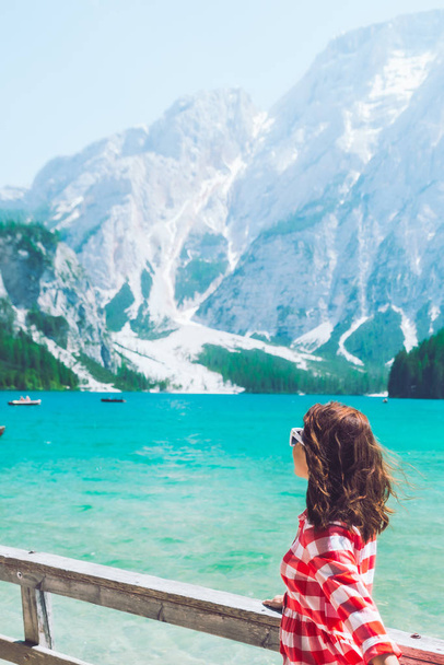 woman standing in front of lake in mountains - Photo, Image
