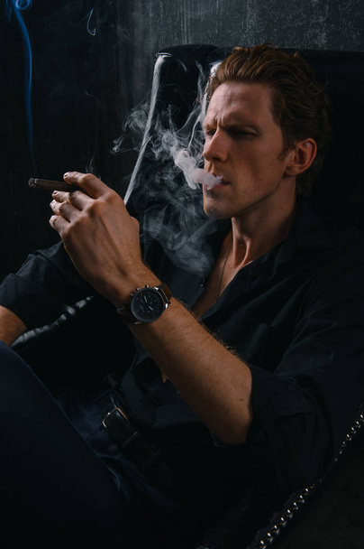 man smoking a cigarette. Cigarette smoke spread. - Photo, Image