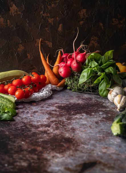 Φρέσκα λαχανικά στο τραπέζι, φυσικά υγιεινά προϊόντα, χορτοφαγικά φαγητά. Ρουστίκ σύνθεση, σκούρο φόντο. - Φωτογραφία, εικόνα