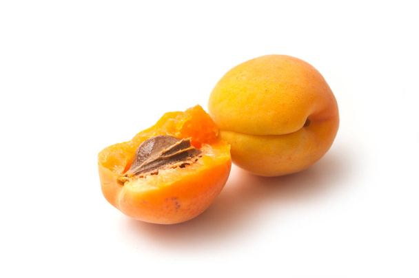 Closeup of organic apricots on white background - Фото, изображение