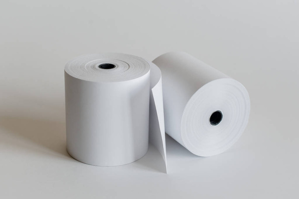Roll of cash register tape isolated on soft gray background. - Photo, Image