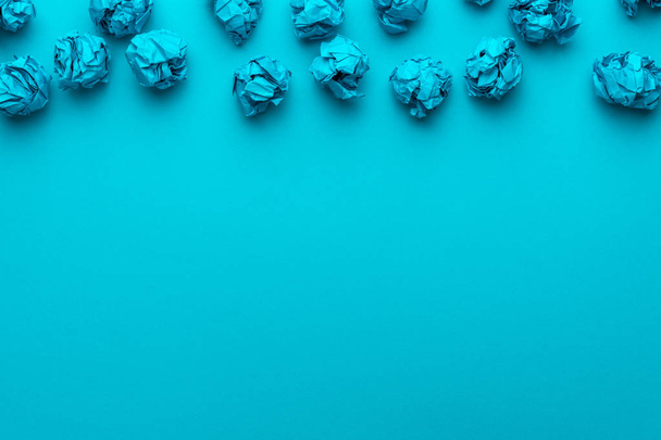 Crumpled paper on turquoise blue background and copy space brainstorming concept - 写真・画像