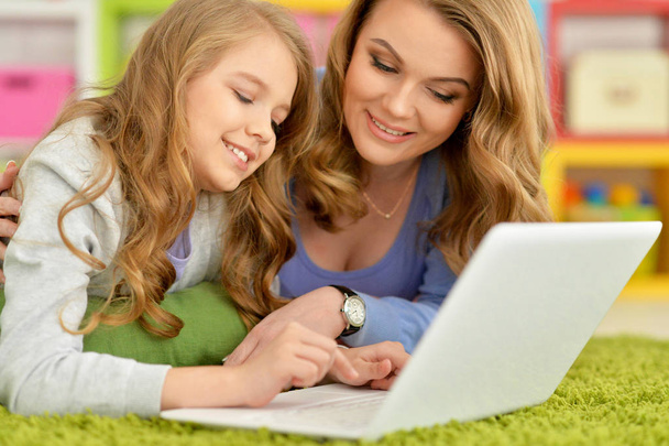 happy mother and daughter using laptop together  - Foto, Imagem