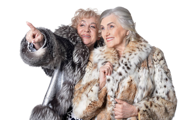 senior women in fur coats looking at something  isolated  on white background - Photo, Image