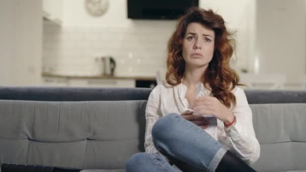 Upset woman watching tv at open kitchen. Closeup depressed woman wiping face - Video, Çekim