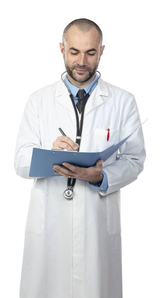 portrait of a caucasian doctor writing notes on a folder.  - Фото, зображення