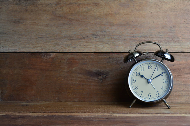 Retro alarm clock on wood background - Photo, Image