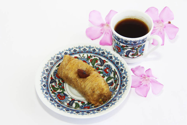Eastern Turkish traditional sweet baklava on colorful plate and a cup of coffee - Foto, imagen
