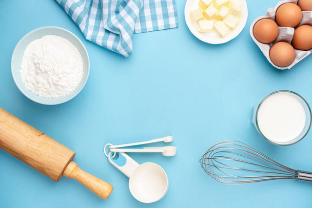 Baking ingredients for bread, pastry or cake on blue background - 写真・画像