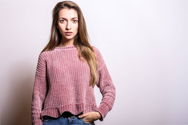 Young model woman in sweater pose in studio. - Photo, image