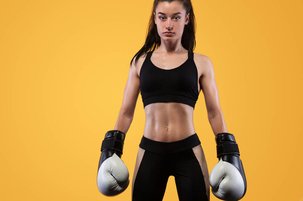 Sportsman, woman boxer fighting in gloves. on yellow background. Boxing and fitness concept. - Φωτογραφία, εικόνα
