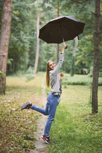 Young woman with umbrella in the forest - Foto, Imagem