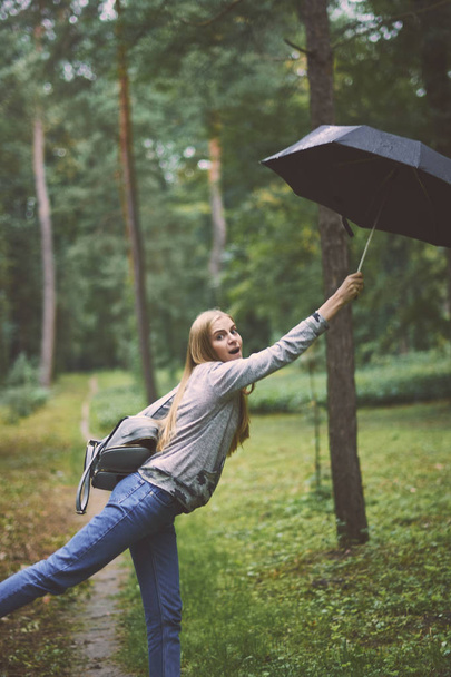 Young woman with umbrella in the forest - Foto, Imagem