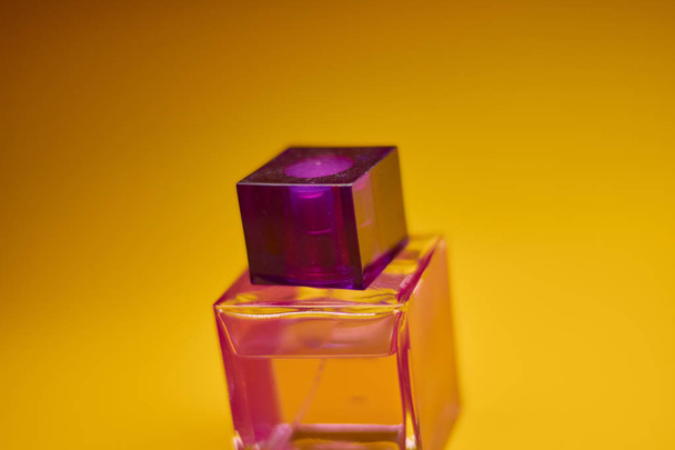 Perfume bottle on yellow background. Minimal style - Foto, Imagem