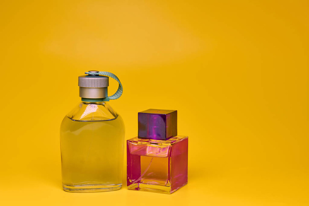 Perfume bottles on yellow background. Minimal style - Foto, Imagen