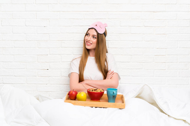 Young woman in dressing gown with breakfast laughing - Photo, Image