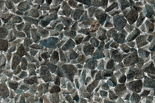 abstrakter Hintergrund aus zerkleinertem Granit. Stein, der für Bauarbeiten in kleine Teile zerkleinert wurde. Sommer. Tag - Foto, Bild