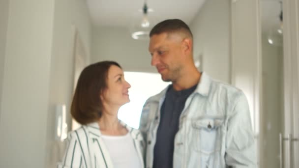 A man is handing the keys to a new apartment to his wife. A couple laughs and rejoices buying a property - Кадры, видео