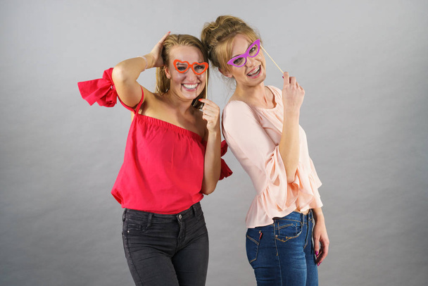 Women with party decoration mask stick glasses - Foto, Imagen