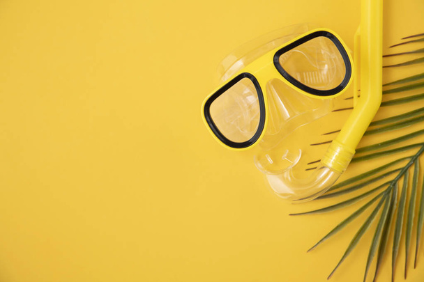 A yellow snorkel and diving mask on a yellow background. overhead lay flat - Foto, imagen
