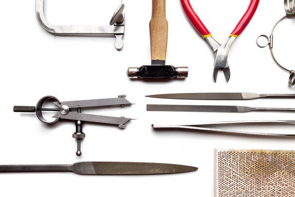 Top view of goldsmiths tools, jewelry objects. Tools over white background - Zdjęcie, obraz