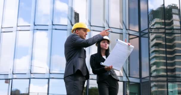 Team of architects and engineer in group on construciton site check documents and business workflow. Engineer inspection in workplace for architectural plan. Concept of: Woman, Man, Suite, Business. - Footage, Video