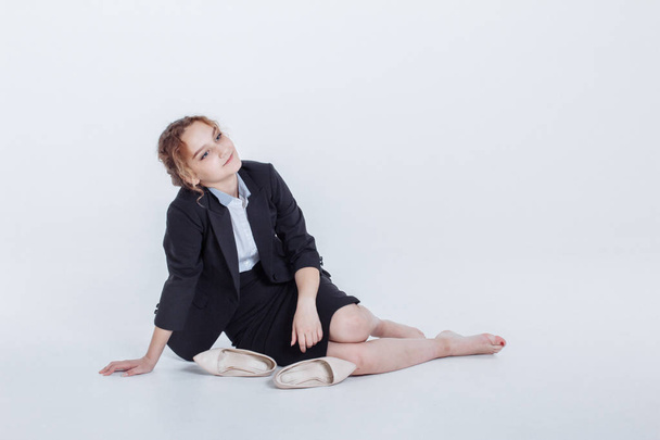 Woman in alcohol intoxication after corporate party. Girl wearing unbuttoned business jacket and takes off shoes from fatigue. Isolated white background - Foto, afbeelding
