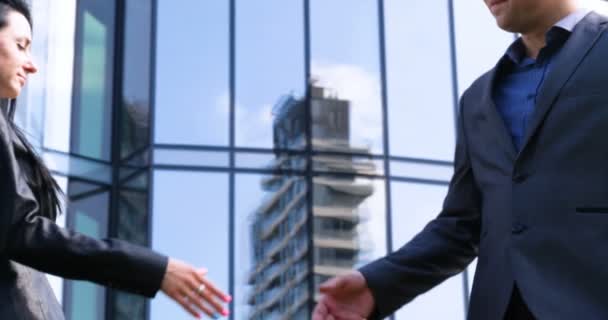 Close up businesswoman and businessman shaking hands Business partnership. Concept of: Skyscraper, Deal, Business building, Architect, Lifestyle. - Footage, Video