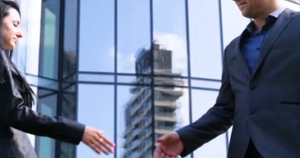 Close up businesswoman and businessman shaking hands Business partnership. Concept of: Skyscraper, Deal, Business building, Architect, Lifestyle. - Footage, Video