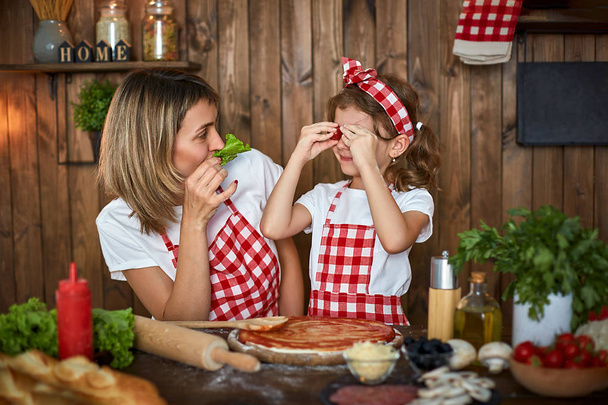 Mother and daughter cooking pizza and have fun - Φωτογραφία, εικόνα