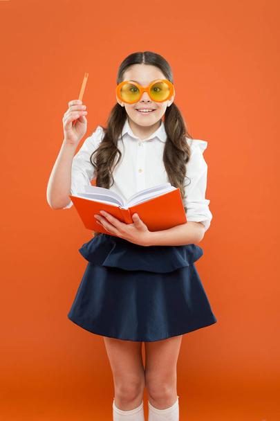 lets write this idea. children literature. get information from book. happy school girl in uniform and party glasses. small child with notebook. literature lesson education. writing in workbook - Φωτογραφία, εικόνα