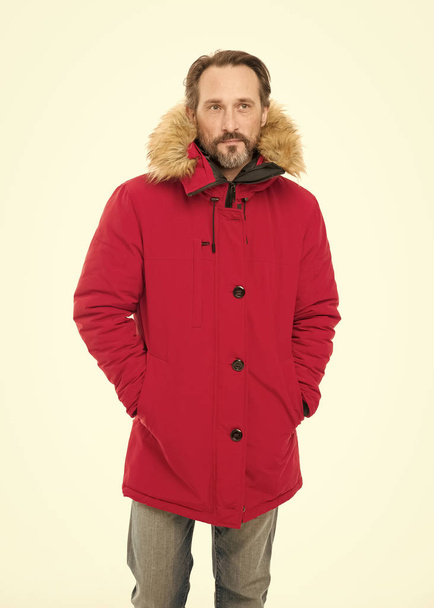 Feeling warm and comfortable. Bearded man wearing hooded jacket. A stylish winter garment protects him from cold. Mature fashion model in cold weather style. Winter wardrobe for senior man - Fotografie, Obrázek
