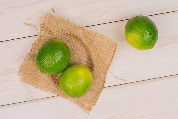 Fresh green lime on grey wood - Photo, Image