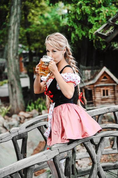 Belle femme caucasienne avec de la bière en robe. Fête d'octobre
. - Photo, image