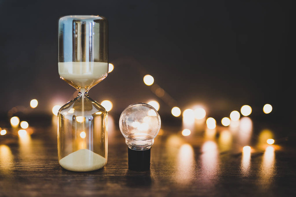 time for new ideas hourglass and lightbulb surrounded by fairy l - Photo, Image