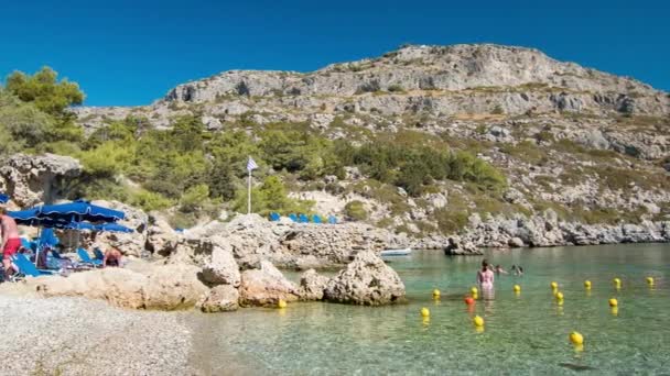 Rhodes Greece Visitors Swimming at Anthony Quinn Bay Playing in the Clear Water at the Popular Greek Island Destination Mediterranean Beach - Imágenes, Vídeo
