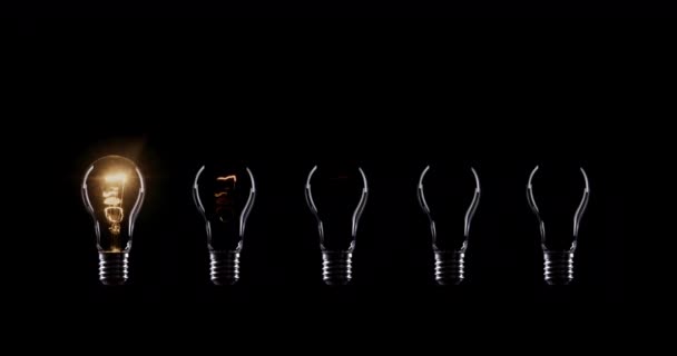 Flickering Tungsten light bulbs lamp over black background - Footage, Video