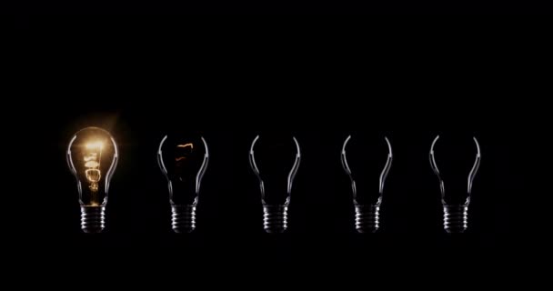Flickering Tungsten light bulbs lamp over black background - Footage, Video